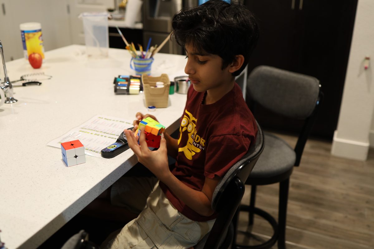 Practicing cubing at the kitchen counter